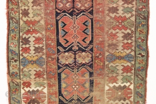 antique long rug, probably nw persian, with an interesting archaic design and older all natural colors. Note the area of white cotton pile seen clearly in back pic. In abused condition, very  ...