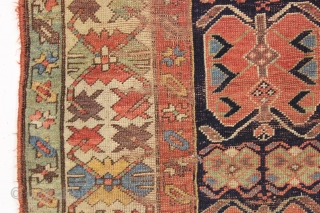 antique long rug, probably nw persian, with an interesting archaic design and older all natural colors. Note the area of white cotton pile seen clearly in back pic. In abused condition, very  ...