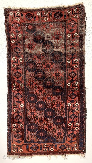 Antique small Baluch rug with classic lattice or tile design field and a lovely archaic floral meander border. Good weave and wool quality. Overall fair condition for an older rug with heavily  ...