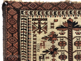 Antique ivory ground Baluch rug with a charming design featuring many good sized animals. The herd of 18 animals (goats? dogs?) flank a traditional Baluch tree motif with interesting corner elements. Overall  ...