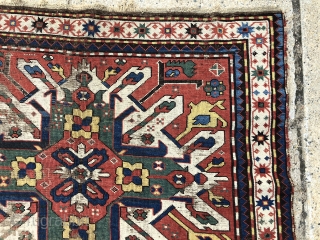 Early eagle karrabagh rug with outstanding color. Unfortunately in very rough condition. All excellent natural colors featuring brilliant yellows and greens. Wear and scattered damage as shown. Some old crude flat stitch  ...