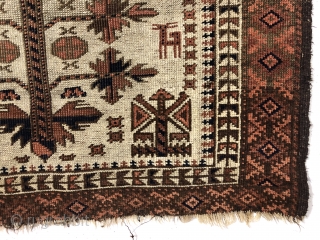 Antique ivory ground Baluch rug with a charming design featuring many good sized animals. The herd of 18 animals (goats? dogs?) flank a traditional Baluch tree motif with interesting corner elements. Overall  ...