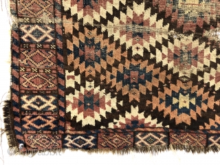 Antique unusual turkman rug fragment, perhaps chodor, with a tight lattice of ashik guls arranged in diagonal color rows on a dark brown ground. Persian knotted open to the right. Appears to  ...