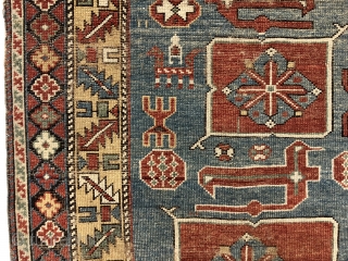 Antique small Caucasian rug in good condition with a dramatic design and attractive colors featuring a lovely yellow main border. The easily recognized karagashli type motifs and numerous animals float on a  ...