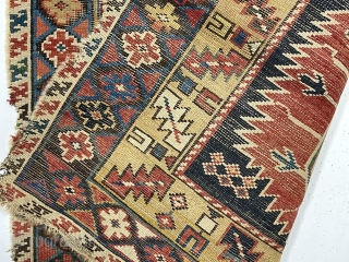 Early east Caucasian rug. Interesting karagashli variant. In rough condition with wear, oxidized browns, holes and edge loss. All natural colors featuring a strong yellow/gold and a fine old green. Good weave.  ...