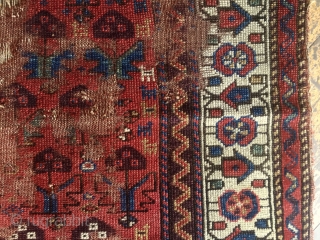 Antique northwest Persian or Kurdish rug or what remains of a rug. Has lovely old natural colors and charming drawing. I like the little border elements that look like houses. Lots of  ...