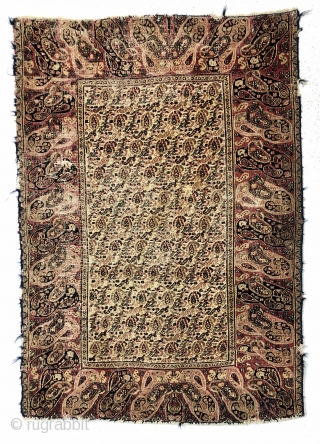 Antique small Persian rug with an appealing mother and daughter boteh border and an intricate ivory ground boteh lattice field. Unfortunately in rough condition with very low pile and much wear. Edges  ...