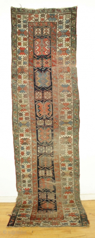 Antique long rug. Northwest persian? Small band of white cotton pile across the field shown in pic. Offered "as found", very very dirty with low pile,  wear, tears. patches, etc. Appears  ...