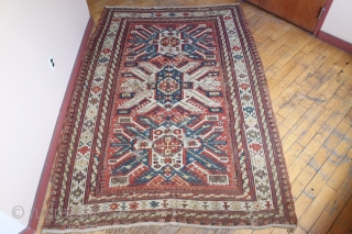 Antique sumak with an unusual design featuring sunbirst or eagle type medalions. Looks like all good old colors. Lots of wear and I see one small hole. Few scattered small old repairs.  ...
