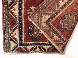 Antique fachralo Kazak prayer rug. Early example with spacious drawing and natural colors. Intact with some decent pile but mostly very low pile, numerous scattered wear spots and a few old little  ...