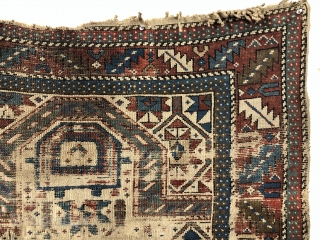 Antediluvian ivory ground Caucasian prayer rug or at least what remains. Possibly early shirvan. Appears to have all wool foundation but interestingly has an area of original white cotton pile. Heavily worn  ...