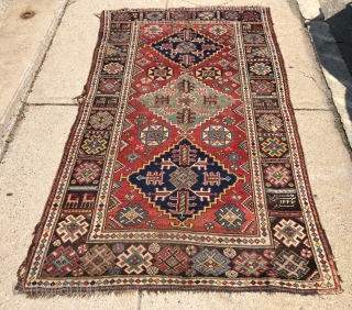 Antique dated Southwest Persian rug with bold drawing and lovely natural colors. Khamseh? Vivid yellows, true greens, good old purples and rich tomato reds. Mostly good pile with some center wear as  ...