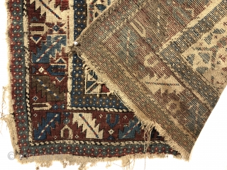 Antediluvian ivory ground Caucasian prayer rug or at least what remains. Possibly early shirvan. Appears to have all wool foundation but interestingly has an area of original white cotton pile. Heavily worn  ...