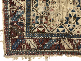 Antediluvian ivory ground Caucasian prayer rug or at least what remains. Possibly early shirvan. Appears to have all wool foundation but interestingly has an area of original white cotton pile. Heavily worn  ...
