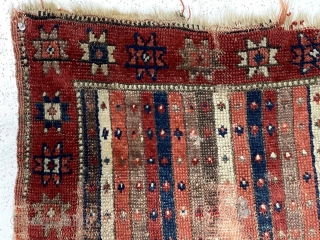 Early Anatolian yastik. Unusual palette for a stripe or cane design field. All natural colors including a lovely soft purple. Remnant original selvages. Substantial wear, small hole, edge unraveling and end loss.  ...