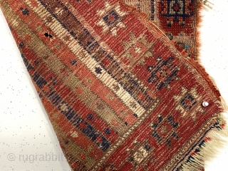 Early Anatolian yastik. Unusual palette for a stripe or cane design field. All natural colors including a lovely soft purple. Remnant original selvages. Substantial wear, small hole, edge unraveling and end loss.  ...