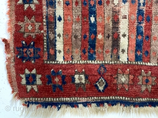 Early Anatolian yastik. Unusual palette for a stripe or cane design field. All natural colors including a lovely soft purple. Remnant original selvages. Substantial wear, small hole, edge unraveling and end loss.  ...