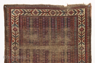 early little baluch rug with an unusual field design and colorful "fish bone" border generally found on older bagfaces. Turkish knotted. Abused and damaged but perhaps of interest to the baluch collector.  ...