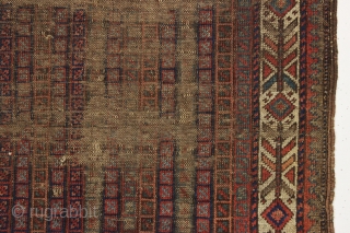 early little baluch rug with an unusual field design and colorful "fish bone" border generally found on older bagfaces. Turkish knotted. Abused and damaged but perhaps of interest to the baluch collector.  ...