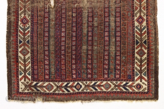 early little baluch rug with an unusual field design and colorful "fish bone" border generally found on older bagfaces. Turkish knotted. Abused and damaged but perhaps of interest to the baluch collector.  ...