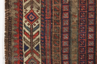 early little baluch rug with an unusual field design and colorful "fish bone" border generally found on older bagfaces. Turkish knotted. Abused and damaged but perhaps of interest to the baluch collector.  ...