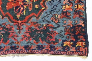 antique seichour rug. Wild and wonderful, a Rorschach test of design. Typical mix of brilliant natural and likely synthetic colors. Overall good condition with good pile. A few tiny spots of black  ...