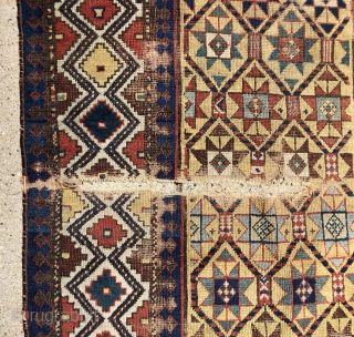 Early yellow ground Caucasian long rug with some unusual design features and excellent saturated natural colors. Kazak? Gendge? Eye catching uncommon ivory border. Unfortunately damaged with a large tear as shown. As  ...