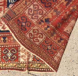 Antique Sewan Kazak rug with great large size and excellent natural colors including pretty greens and a good tomato red. Less common “dumbbell” medallion. Intact, but unfortunately not in good condition with  ...