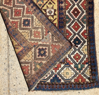 Early yellow ground Caucasian long rug with some unusual design features and excellent saturated natural colors. Kazak? Gendge? Eye catching uncommon ivory border. Unfortunately damaged with a large tear as shown. As  ...