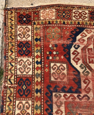 Antique Sewan Kazak rug with great large size and excellent natural colors including pretty greens and a good tomato red. Less common “dumbbell” medallion. Intact, but unfortunately not in good condition with  ...