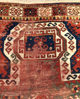 Antique Sewan Kazak rug with great large size and excellent natural colors including pretty greens and a good tomato red. Less common “dumbbell” medallion. Intact, but unfortunately not in good condition with  ...