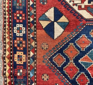 Antique large Kazak rug in fair condition with classic ivory Lori Pombak medallions. Good original natural colors with an abrashed tomato red ground and both light and dark blues. Overall good even  ...