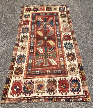 Early Kazak rug with an uncommon field design and an eye catching border. The best example of this type I have encountered. Beautiful old natural colors including lovely old greens. Overall low  ...