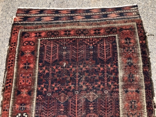 Early blue ground Baluch rug. A small timuri main carpet? Good variety of archaic field motifs and an elegant border. All natural colors. Overall thin with very low pile with areas of  ...