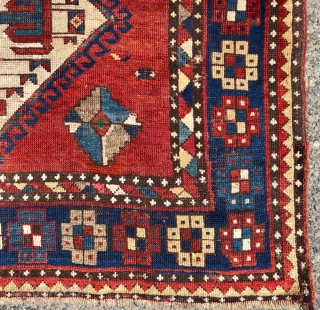 Antique large Kazak rug in fair condition with classic ivory Lori Pombak medallions. Good original natural colors with an abrashed tomato red ground and both light and dark blues. Overall good even  ...