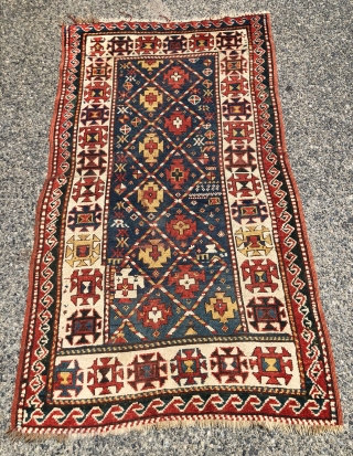 Antique small kazak rug with an uncommon all over design. Freely drawn with a fun candy cane lattice. As found, very very dirty but i can see under the grime the colors  ...
