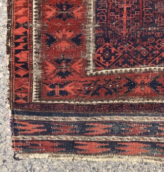 Early blue ground Baluch rug. A small timuri main carpet? Good variety of archaic field motifs and an elegant border. All natural colors. Overall thin with very low pile with areas of  ...