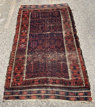 Early blue ground Baluch rug. A small timuri main carpet? Good variety of archaic field motifs and an elegant border. All natural colors. Overall thin with very low pile with areas of  ...
