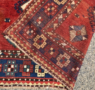 Antique large Kazak rug in fair condition with classic ivory Lori Pombak medallions. Good original natural colors with an abrashed tomato red ground and both light and dark blues. Overall good even  ...