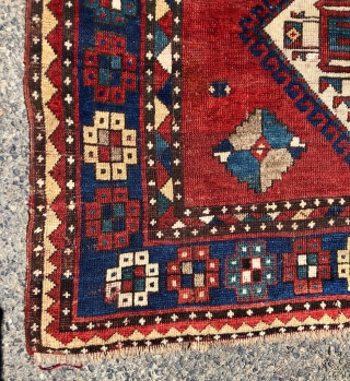 Antique large Kazak rug in fair condition with classic ivory Lori Pombak medallions. Good original natural colors with an abrashed tomato red ground and both light and dark blues. Overall good even  ...