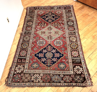 Antique good sized southwest Persian rug, unusually dated (1237?) possibly khamseh, in fairly good condition. Attractive design featuring a large green medallion and an interesting border with animals. Few small old repairs.  ...