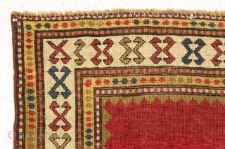 antique very small kazak rug with a mystifying empty field. Good even low pile. All lovely natural colors. Clean. A little jewel. ca. 1875 2'10" x 3'7"      