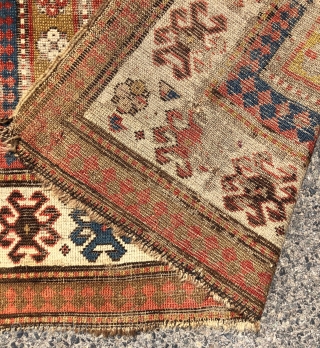 Early Kazak rug with a dramatic design and rich older colors unfortunately in very rough condition. An interesting mix of compartment and borjalou Kazak types. Pile varies from low to very low  ...