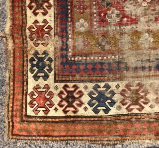 Early Kazak rug with a dramatic design and rich older colors unfortunately in very rough condition. An interesting mix of compartment and borjalou Kazak types. Pile varies from low to very low  ...