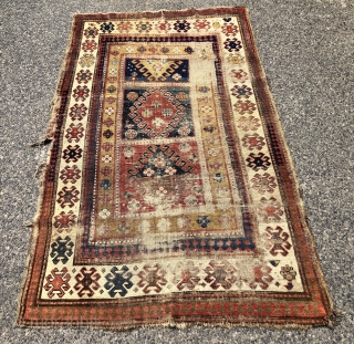 Early Kazak rug with a dramatic design and rich older colors unfortunately in very rough condition. An interesting mix of compartment and borjalou Kazak types. Pile varies from low to very low  ...