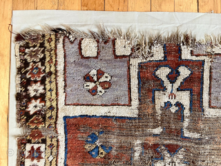 Early Turkish prayer rug fragment. Coarse and rugged. Lovely purple. First half 19th c. or earlier. 
43” x 55” not including cloth mounting.          