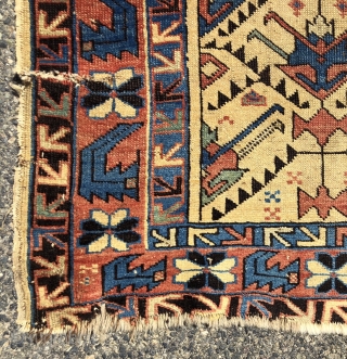 Antique yellow ground Caucasian rug, probably Avar, with a spacious lattice of large tulip palmettes. Overall even very low pile with scattered wear as shown. Small edge tear and a spot or  ...