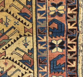 Antique yellow ground Caucasian rug, probably Avar, with a spacious lattice of large tulip palmettes. Overall even very low pile with scattered wear as shown. Small edge tear and a spot or  ...