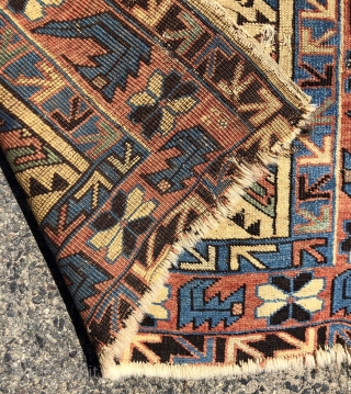 Antique yellow ground Caucasian rug, probably Avar, with a spacious lattice of large tulip palmettes. Overall even very low pile with scattered wear as shown. Small edge tear and a spot or  ...