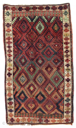 antique kurdish rug with classic diamond design field and some unusual features. Interesting quirky designs added to either end of the field and unusual very light green pile. This very light green  ...